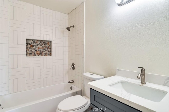 full bathroom with tiled shower / bath combo, vanity, and toilet