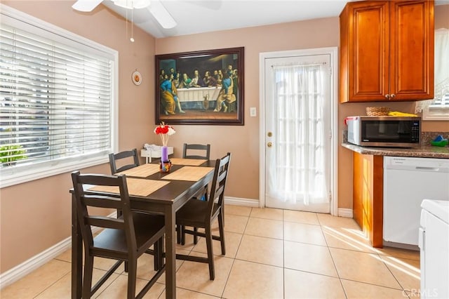 dining room with ceiling fan, a wealth of natural light, and light tile patterned floors