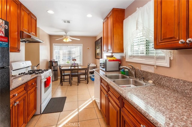 kitchen with ceiling fan, white appliances, sink, and light tile patterned floors