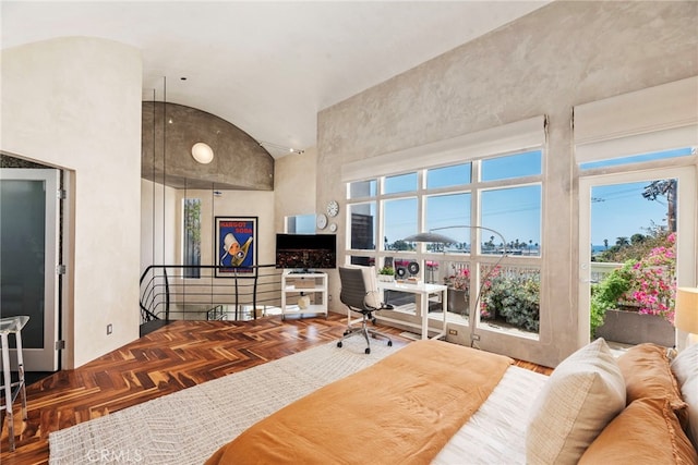 bedroom featuring parquet floors and a high ceiling