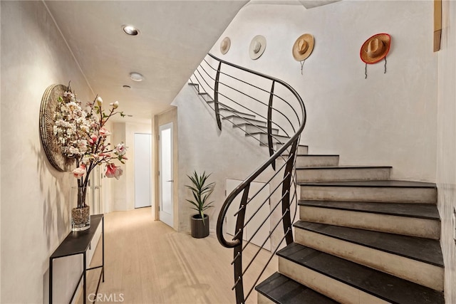 stairs featuring hardwood / wood-style flooring