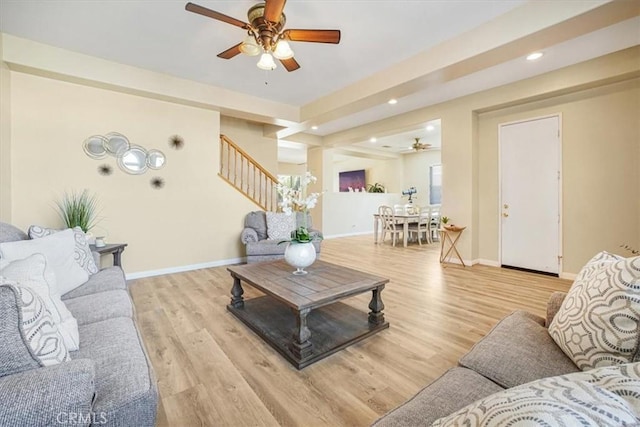 living area featuring ceiling fan, recessed lighting, baseboards, stairs, and light wood-type flooring