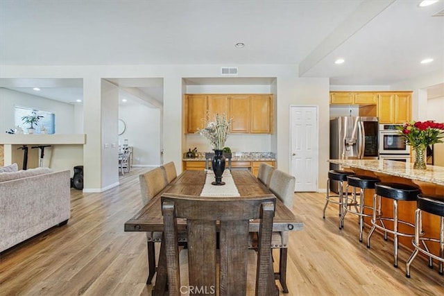 dining room featuring baseboards, recessed lighting, visible vents, and light wood-style floors