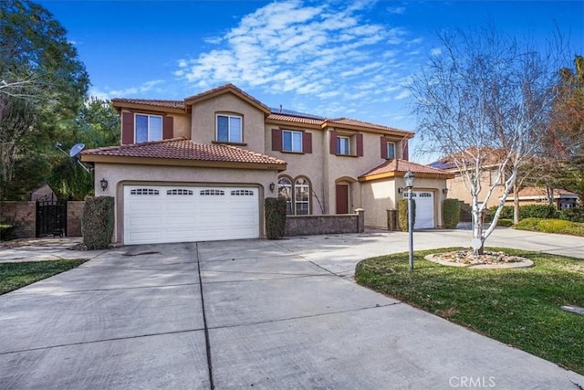 mediterranean / spanish-style home featuring concrete driveway, a tile roof, an attached garage, and stucco siding