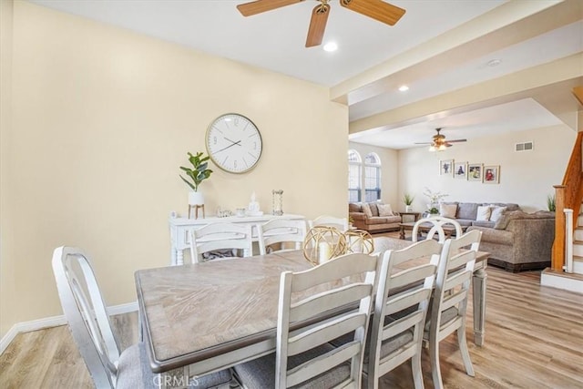 dining space with visible vents, stairway, a ceiling fan, light wood-type flooring, and baseboards