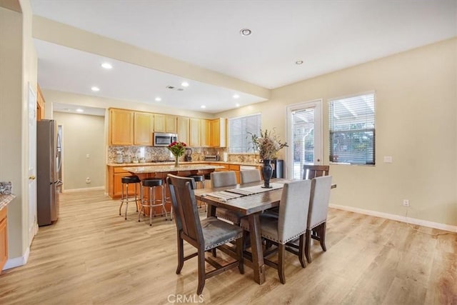 dining space with light wood-type flooring, baseboards, and recessed lighting