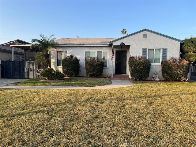 ranch-style home with a front lawn and stucco siding