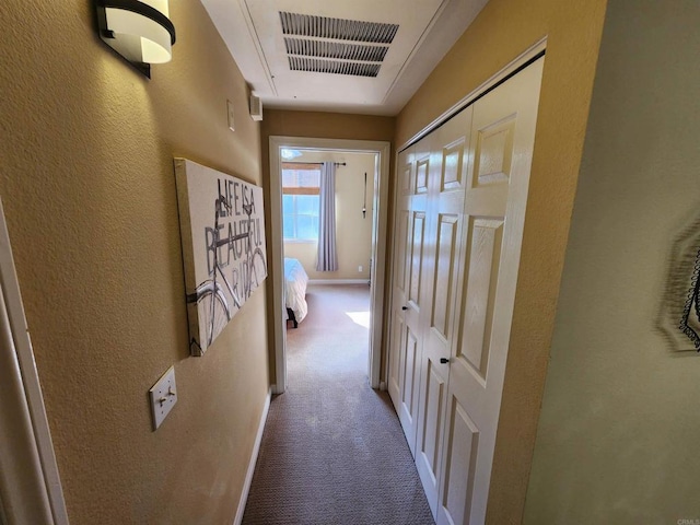 corridor with light colored carpet