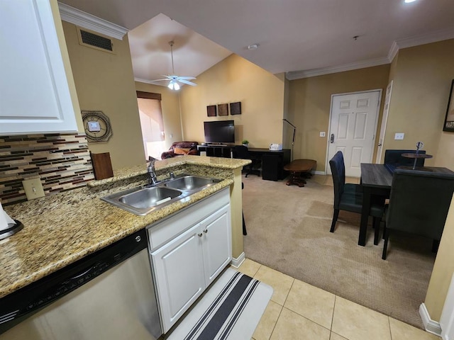 kitchen with sink, crown molding, light carpet, stainless steel dishwasher, and white cabinets