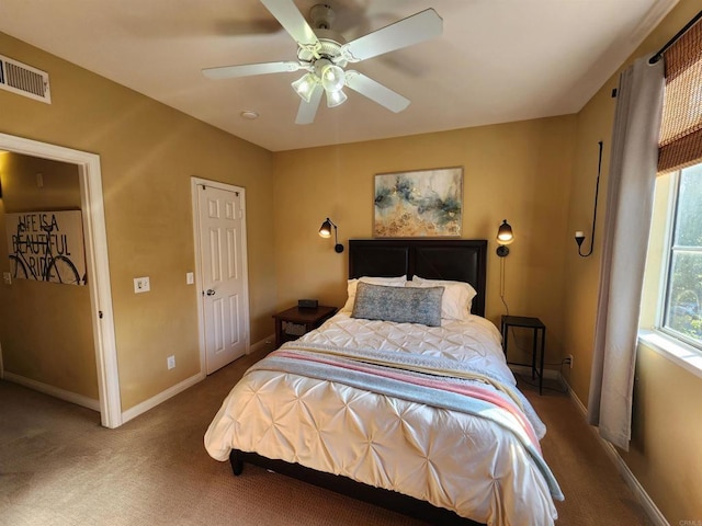 bedroom featuring ceiling fan and carpet