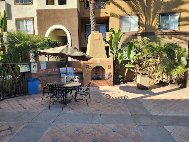 view of patio / terrace featuring an outdoor fireplace, grilling area, and exterior kitchen