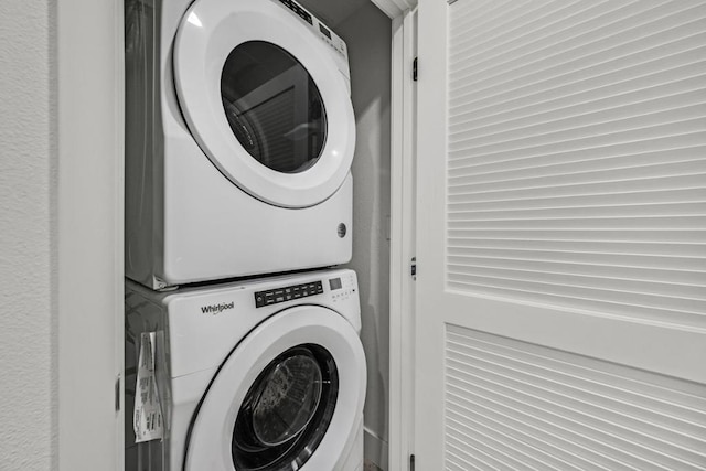 washroom with stacked washer / drying machine