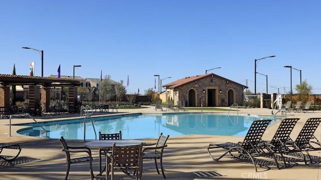 view of swimming pool featuring a patio and a pergola