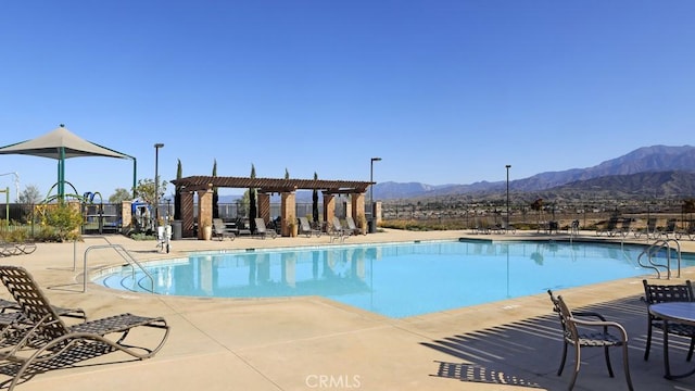 view of pool featuring a mountain view, a patio area, and a pergola