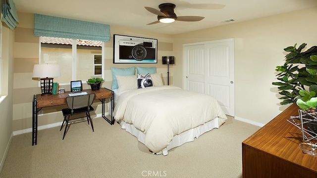 carpeted bedroom featuring ceiling fan and a closet