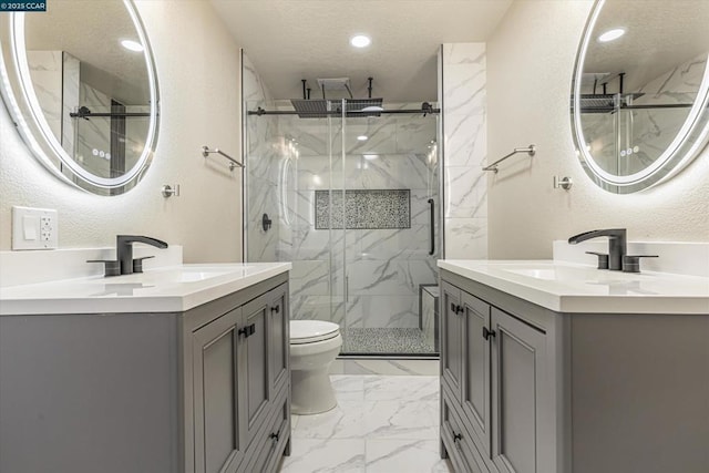 bathroom featuring toilet, vanity, a textured ceiling, and walk in shower