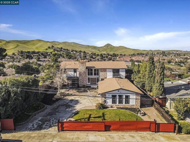 exterior space featuring a mountain view and a front lawn