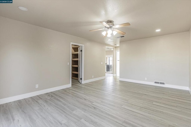 spare room featuring ceiling fan and light wood-type flooring