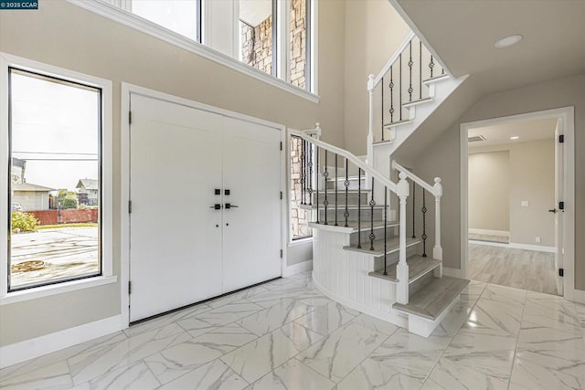 entrance foyer featuring a towering ceiling