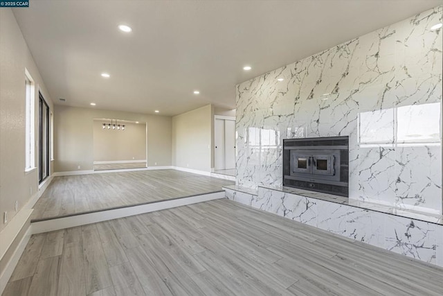 unfurnished living room with hardwood / wood-style flooring and a high end fireplace