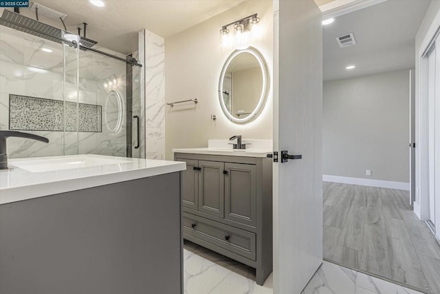 bathroom featuring vanity and a shower with shower door