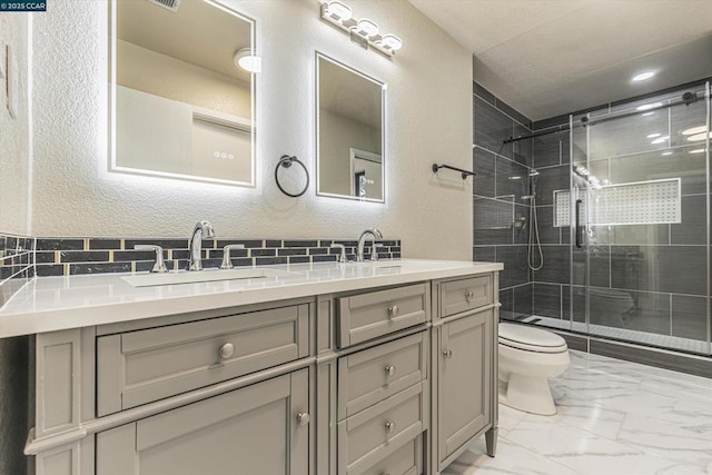 bathroom with vanity, toilet, and a shower with shower door