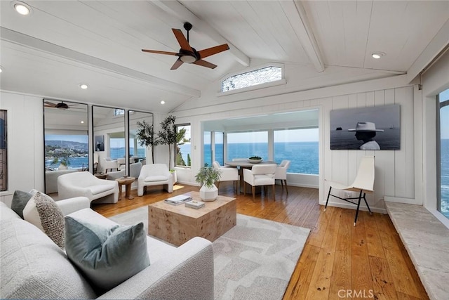 sunroom featuring vaulted ceiling with beams, ceiling fan, and a water view