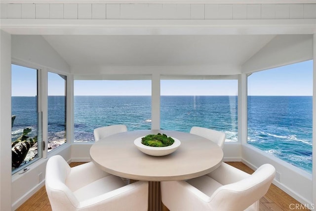 balcony featuring a water view and a beach view