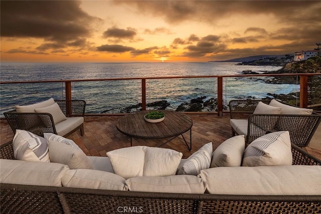 balcony with a water view and an outdoor hangout area