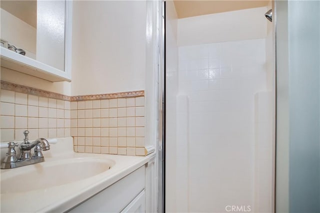 bathroom with vanity and tile walls