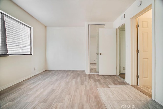 spare room featuring light hardwood / wood-style flooring