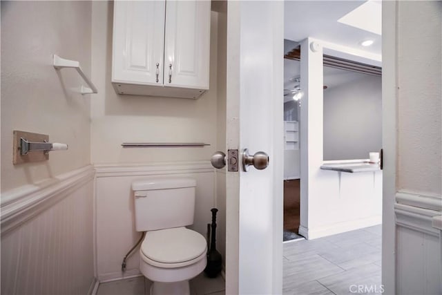 bathroom featuring ceiling fan and toilet