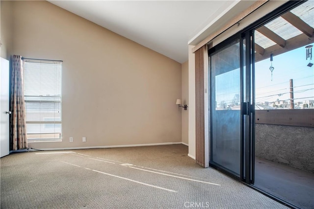 carpeted empty room with lofted ceiling