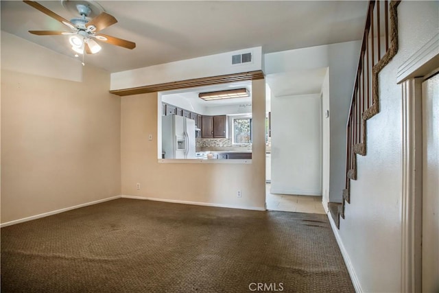 empty room featuring carpet flooring and ceiling fan