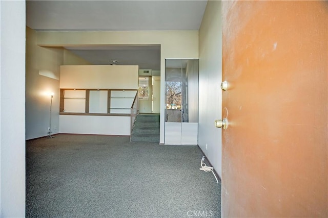 empty room featuring dark colored carpet