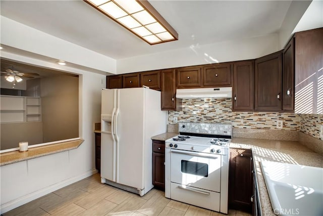 kitchen with backsplash, white appliances, dark brown cabinets, and ceiling fan