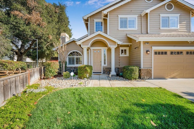 view of front of home featuring a garage and a front lawn