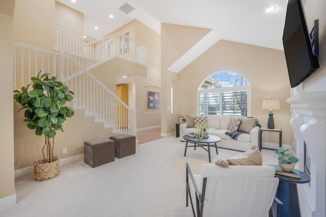 carpeted living room featuring a high ceiling