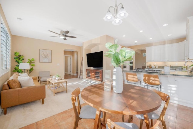 dining area with sink, ceiling fan, and light tile patterned flooring