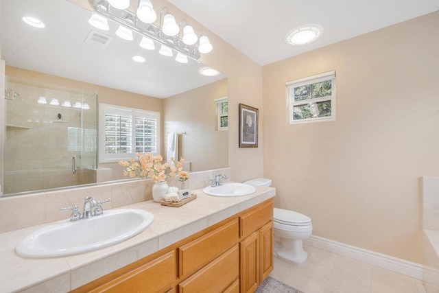 bathroom featuring an enclosed shower, vanity, plenty of natural light, and toilet