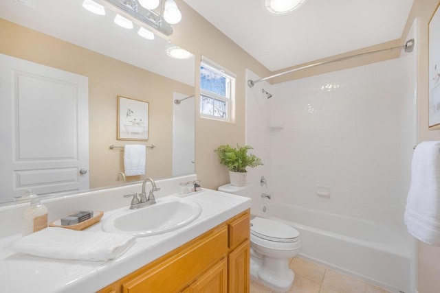 full bathroom featuring vanity, tile patterned flooring, tiled shower / bath combo, and toilet