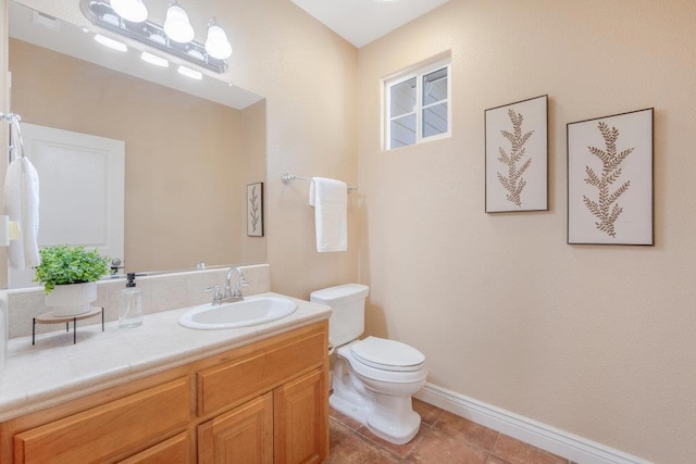 bathroom featuring vanity, tile patterned floors, and toilet