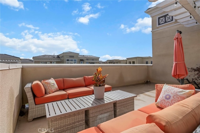 view of patio / terrace with a balcony and an outdoor hangout area