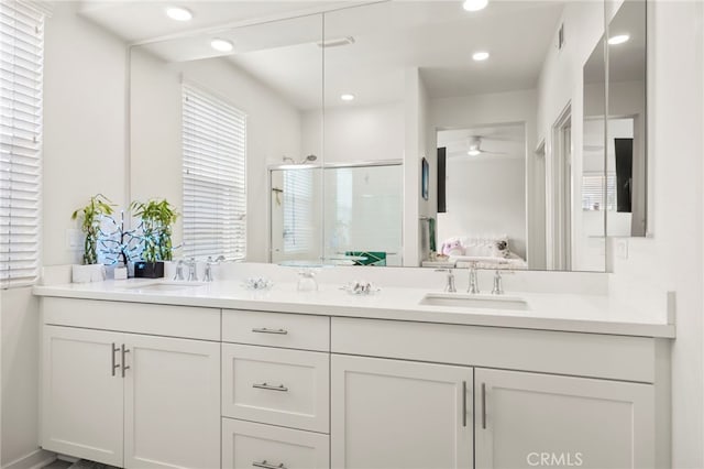 bathroom featuring vanity and an enclosed shower