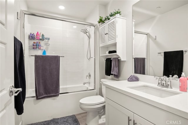 full bathroom featuring vanity, tile patterned floors, shower / bath combination with glass door, and toilet