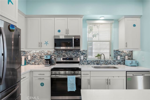 kitchen featuring white cabinetry, stainless steel appliances, sink, and backsplash