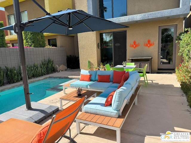 view of swimming pool with an outdoor living space and a patio area