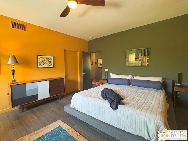 bedroom with ceiling fan and dark hardwood / wood-style flooring