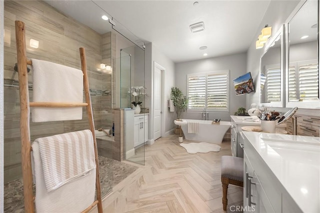 full bathroom featuring visible vents, a soaking tub, vanity, and a shower stall