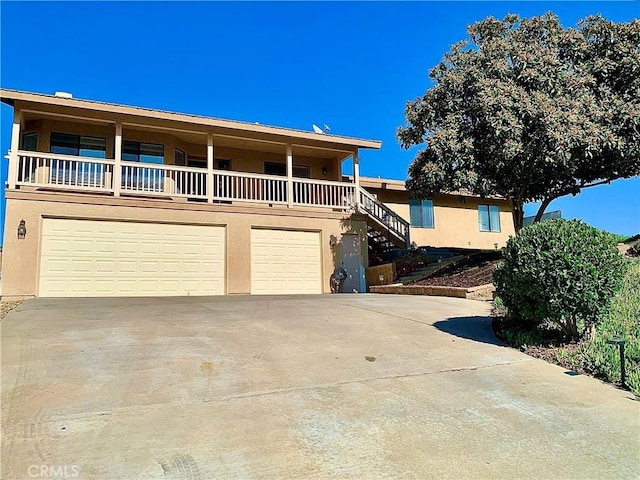 view of front of property featuring a garage and a balcony